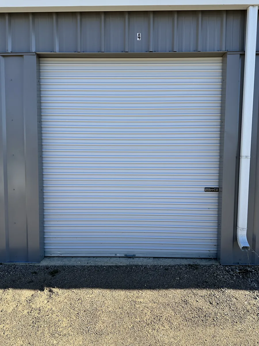Bay 4, a 10×30 storage bay with its white roll-up door closed