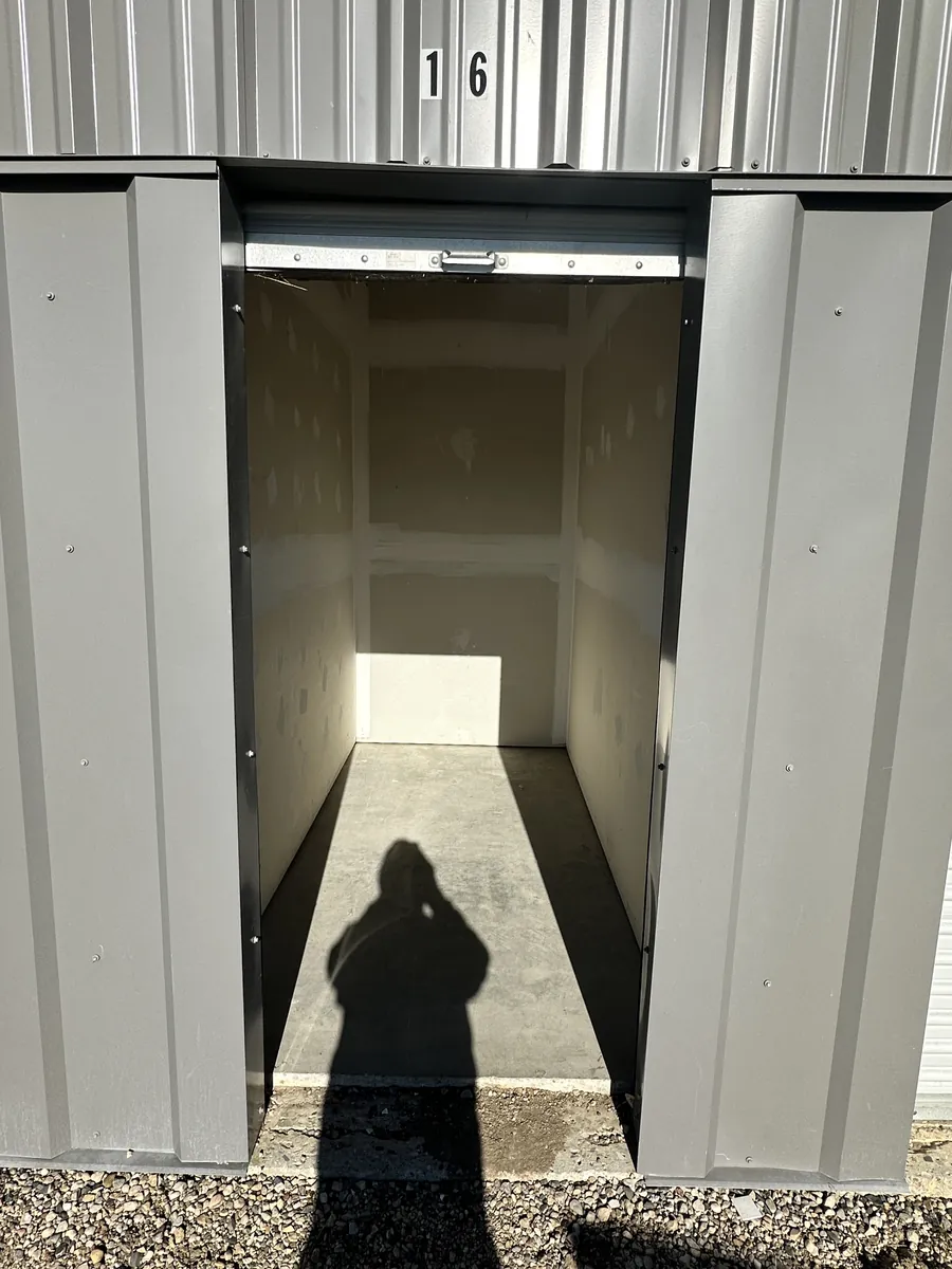 Bay 16, a 5×10 storage bay with the roll-up door open, empty inside