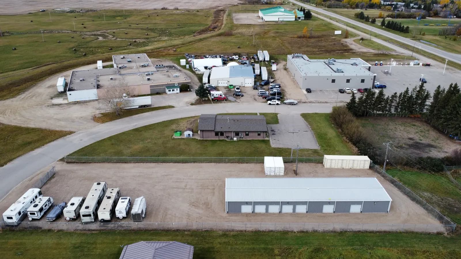 Aerial of the fenced lot, storage building, and containers