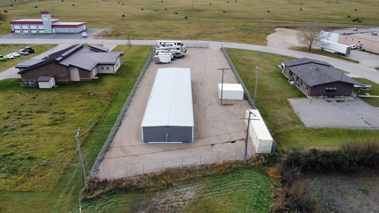 Lower aerial of the lot, roadside sign, and parked RVs